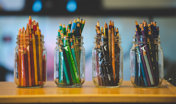 Colored pencils arranged artistically in mason jars