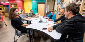 A group of educators talking around a table