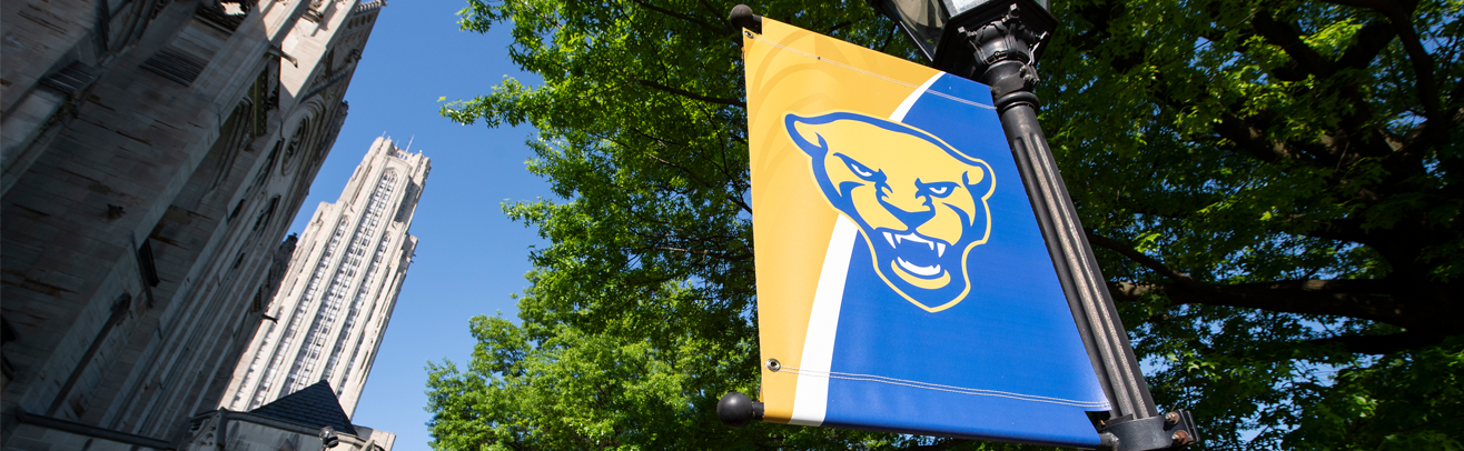 Sign with Pitt Panther face with Cathedral of Learning in background