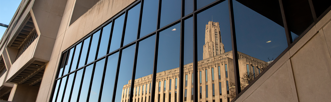 image of cathedral of learning reflected off Posvar Hall glass