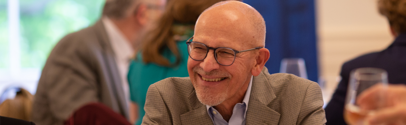 An older man smiling at an awards event